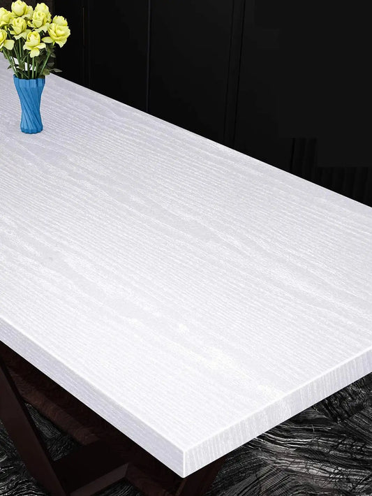 Table top covered in white wood effect adhesive vinyl, with a vase of flowers