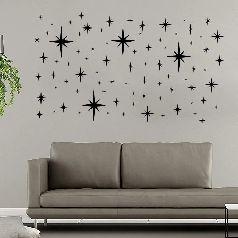 Black sparkling stars above a grey sofa
