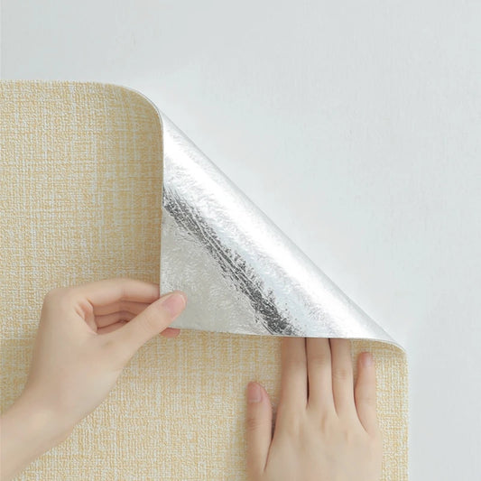 Hands removing the protective film from the back of a beige adhesive roll