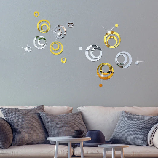 Silver and gold mirror circles on a grey wall above a sofa