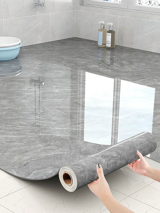 Grey marble-effect self-adhesive roll, unrolled over a bathroom floor