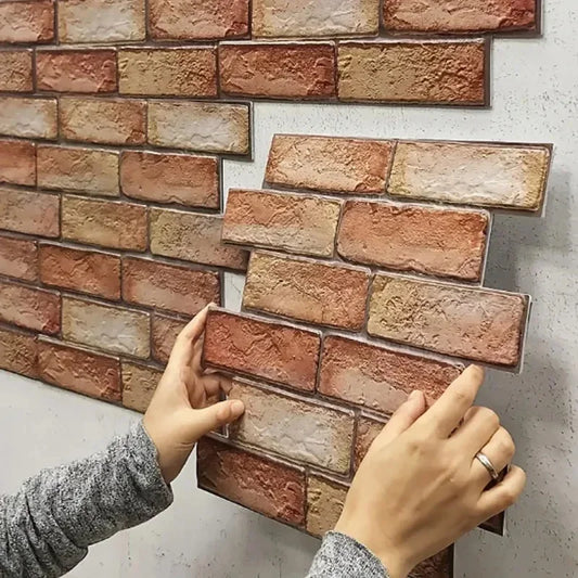 Hands fitting a 3D brick effect panel next to those already on the wall