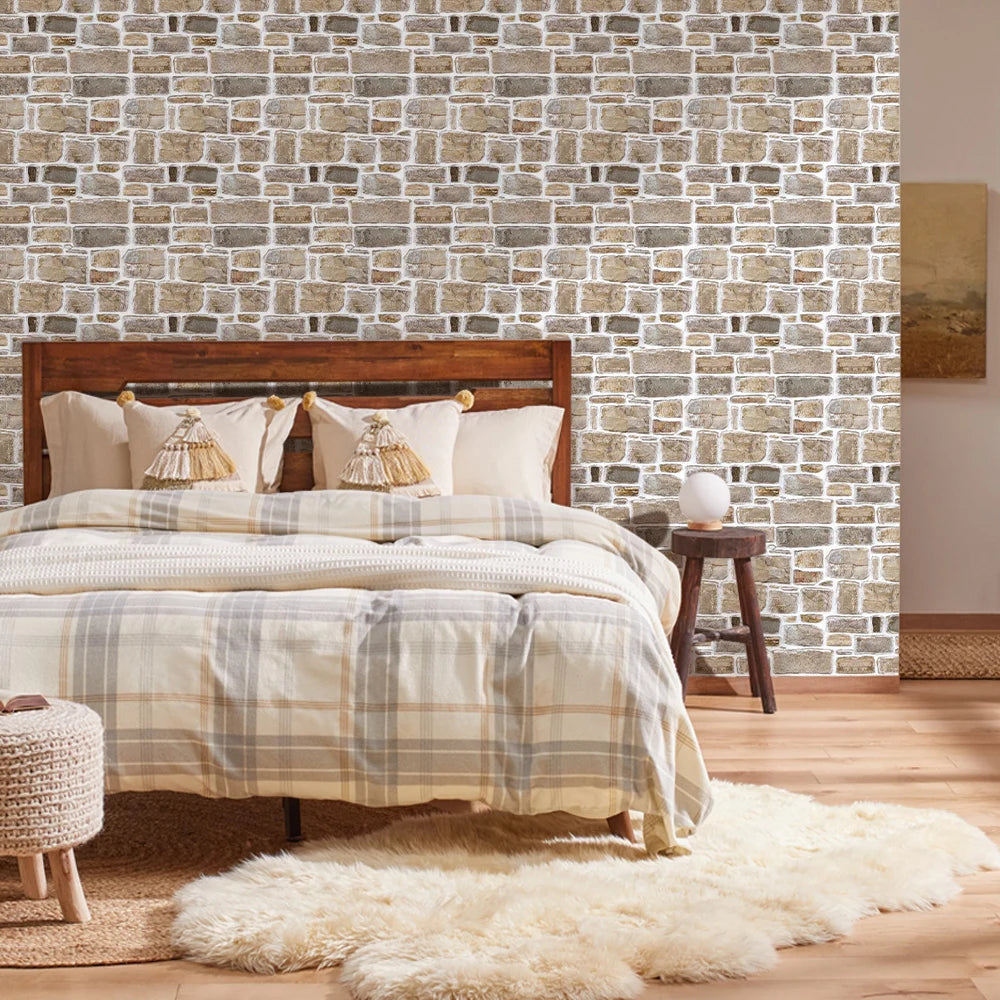 Bedroom with the wall behind the bed clad in brown-grey stone effect panels