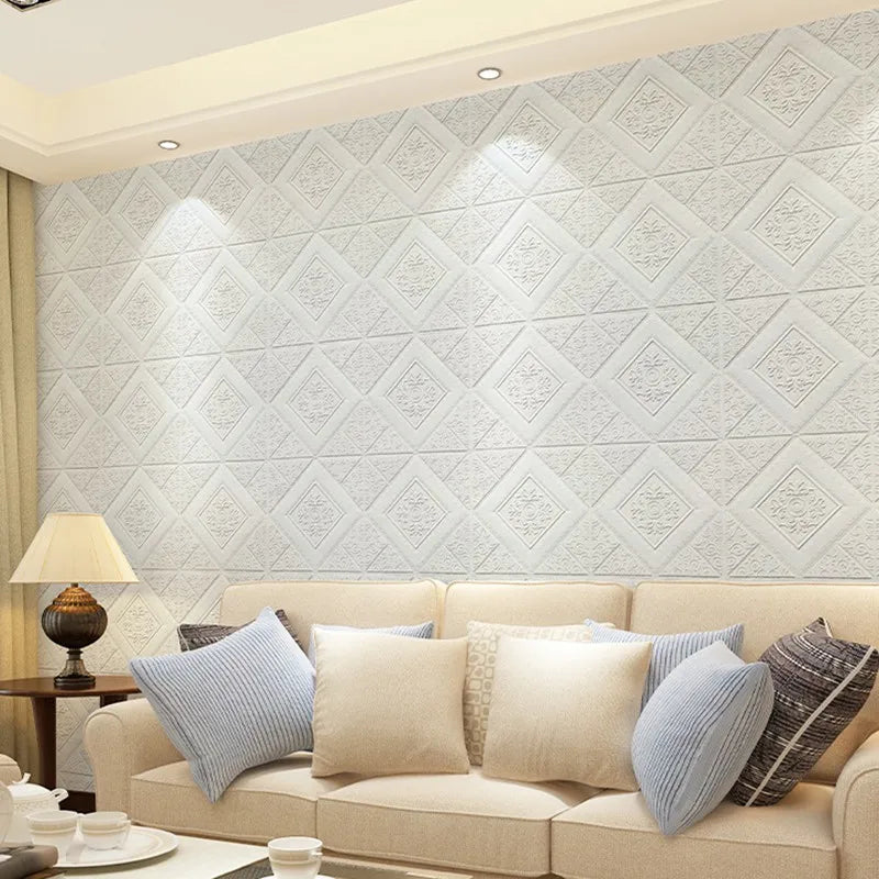 Living room wall covered with white 3D foam diamond panels behind a sofa