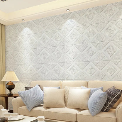 Living room wall covered with white 3D foam diamond panels behind a sofa