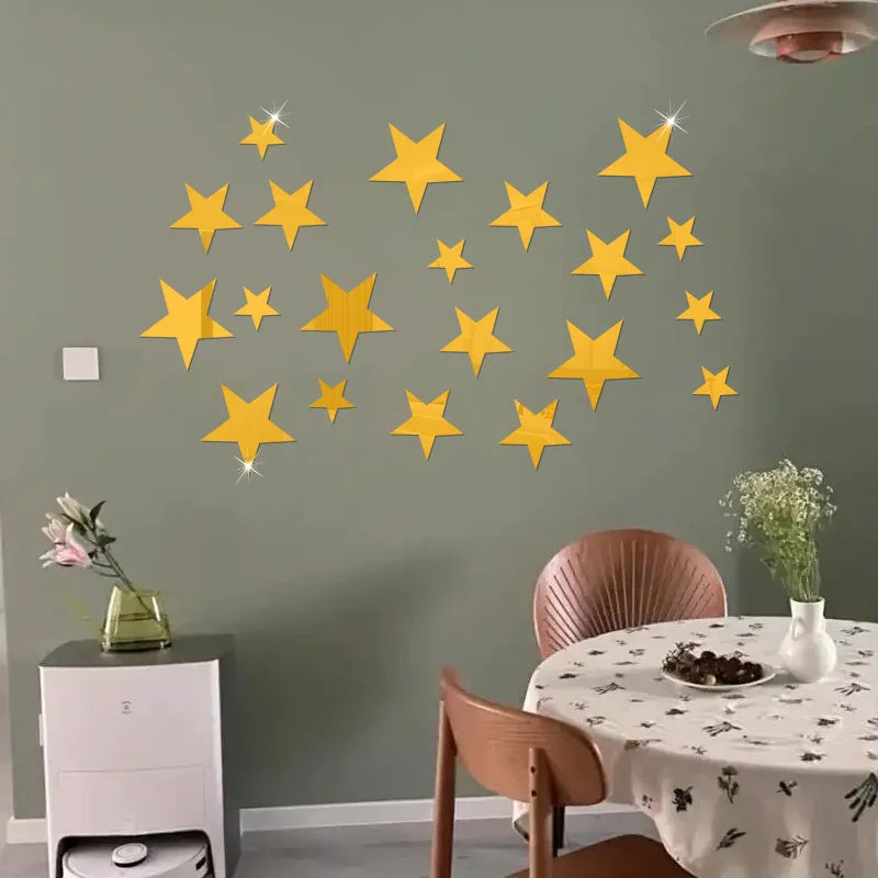 Gold five-pointed stars on a grey-green wall above a table