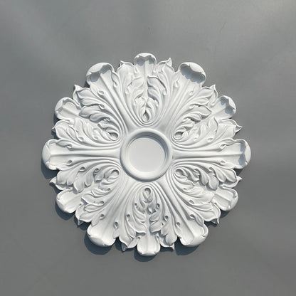Decorative white polyurethane ceiling rose with leaf relief, seen from above, on a grey background