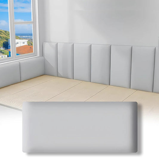 Corner of a room with grey padded panels and a grey panel in the foreground