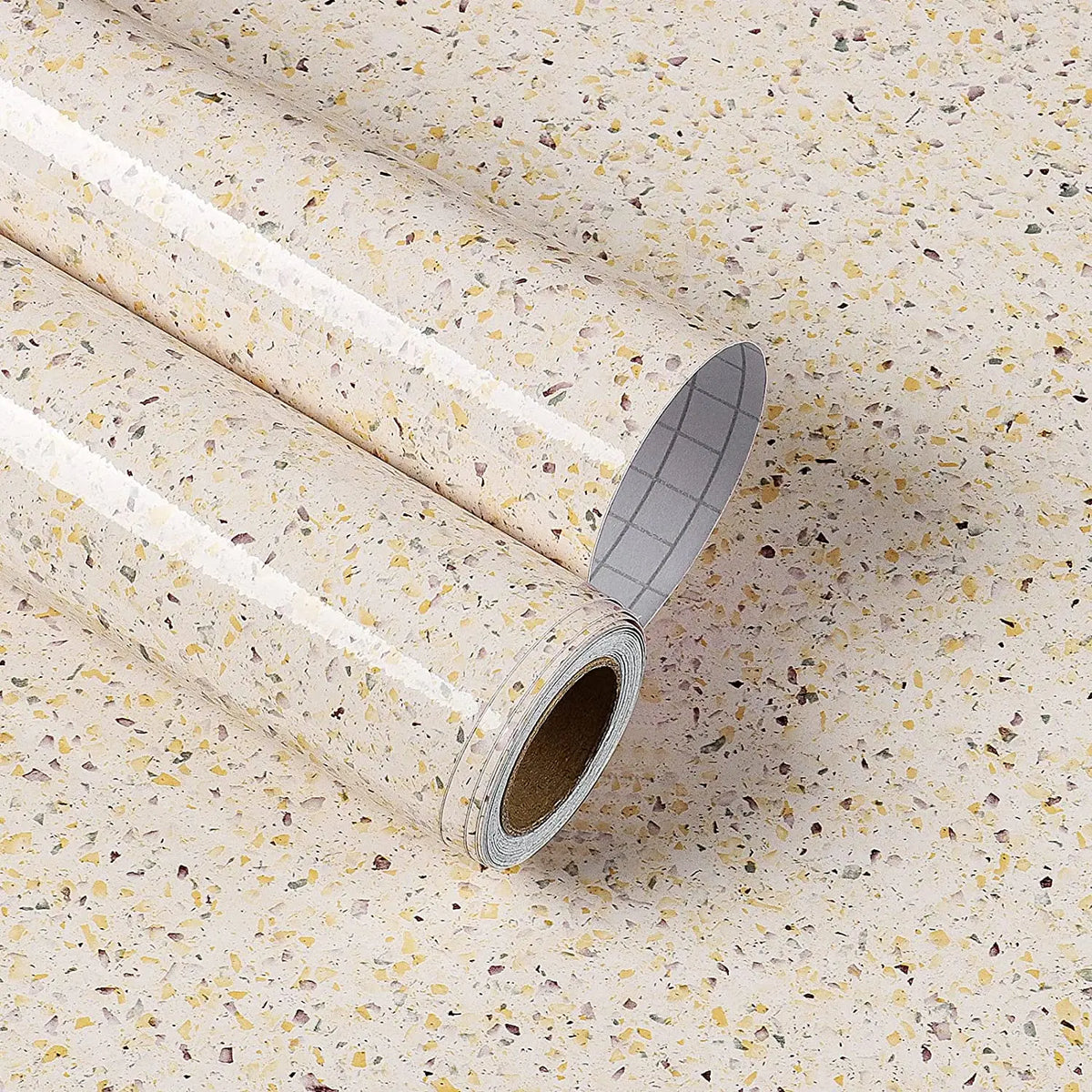Rolle beige Möbelfolie in Terrazzooptik mit Schutzpapier mit Raster auf der Rückseite