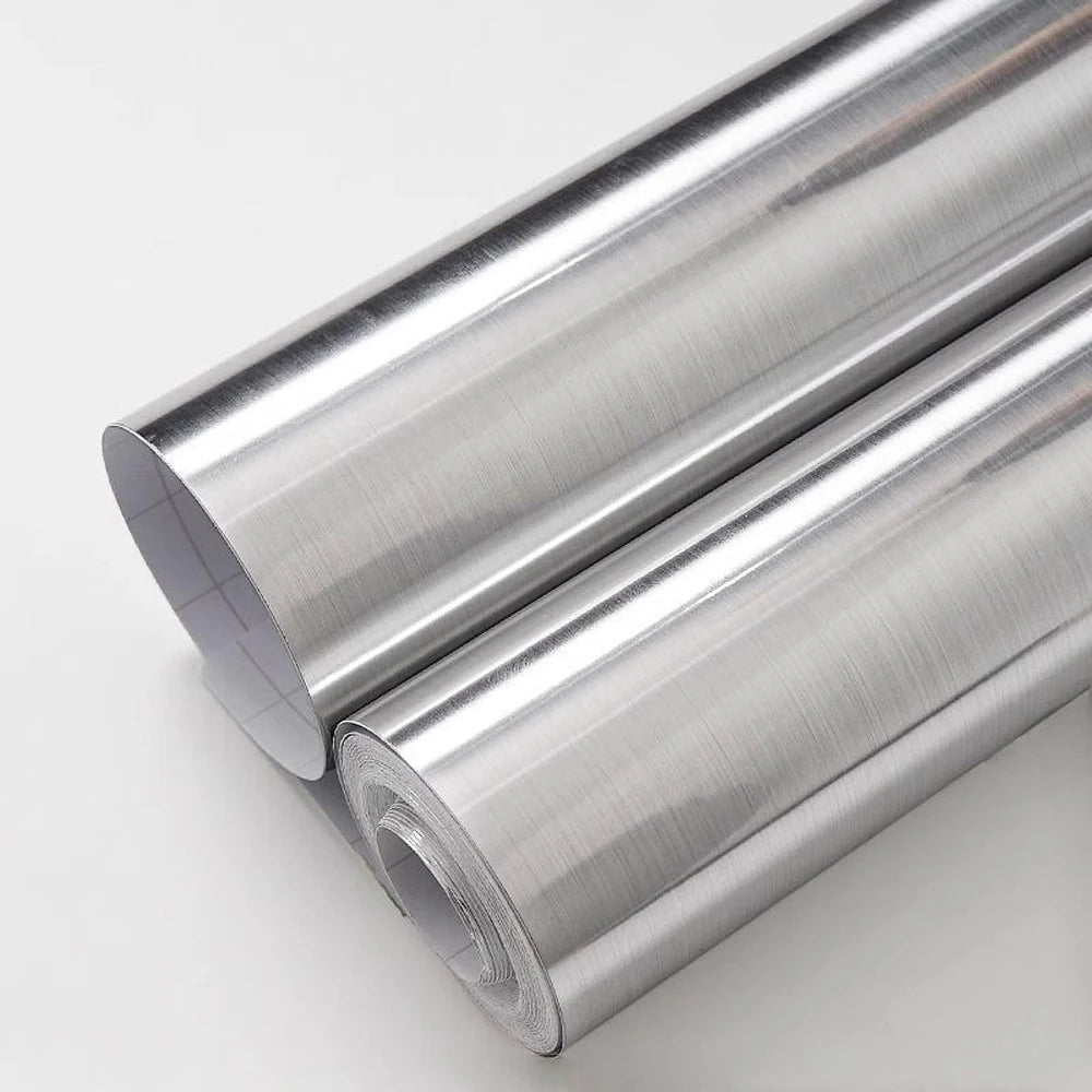 Two rolls of silver brushed stainless steel effect adhesive vinyl on a light background