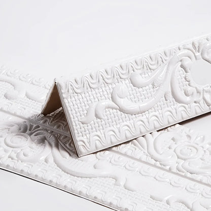 White self-adhesive moulding with raised decoration, folded in a V on a white background