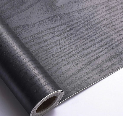 Roll of black wood effect self-adhesive vinyl with dark grey grain
