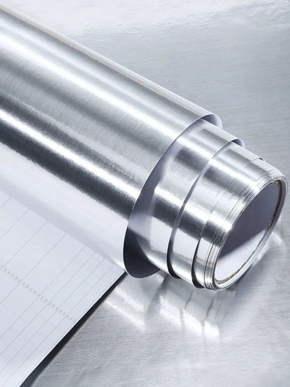 Roll of silver vinyl with the white grid backing visible at the edge