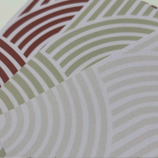 Three tile stickers with arches in terracotta, olive green and cream, overlapping, in close-up
