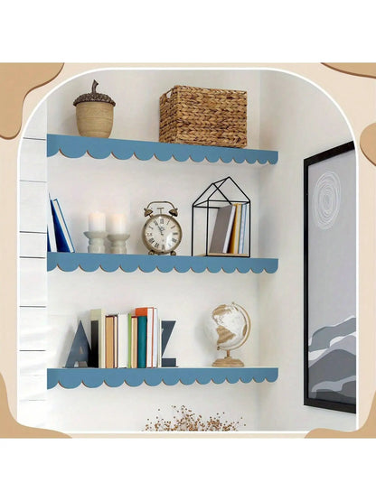Three wall shelves with scalloped wooden mouldings painted light blue