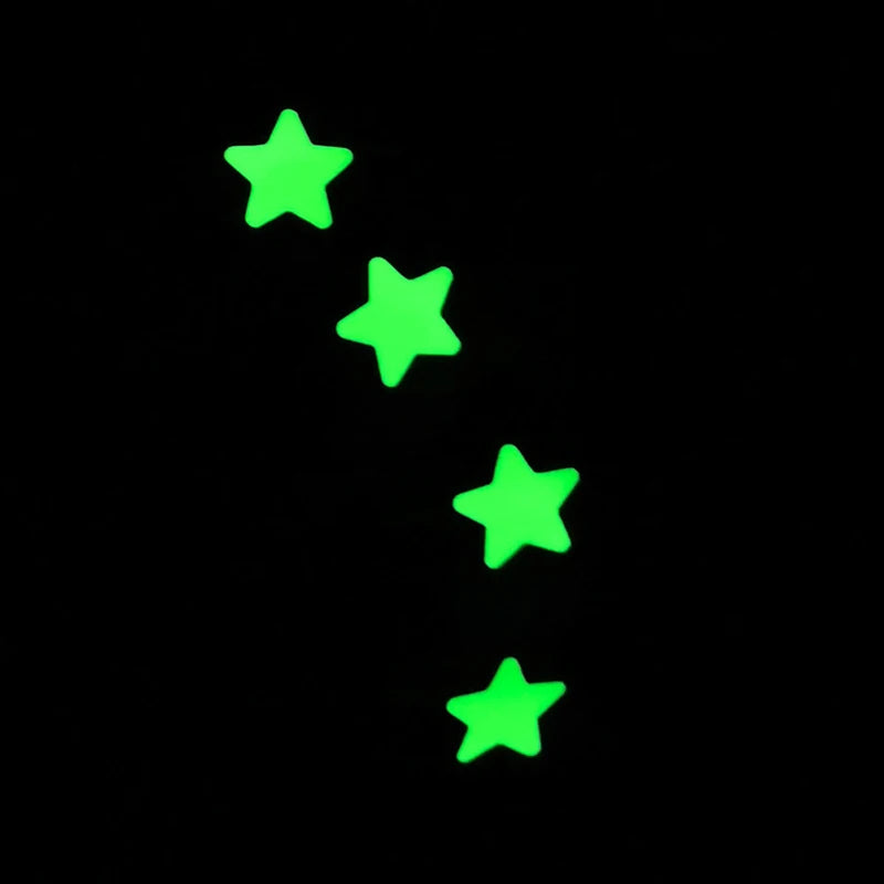 Four glow in the dark stars on a black background