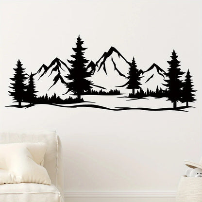 Mountain and pine sticker on a light wall above a bed with beige cushions