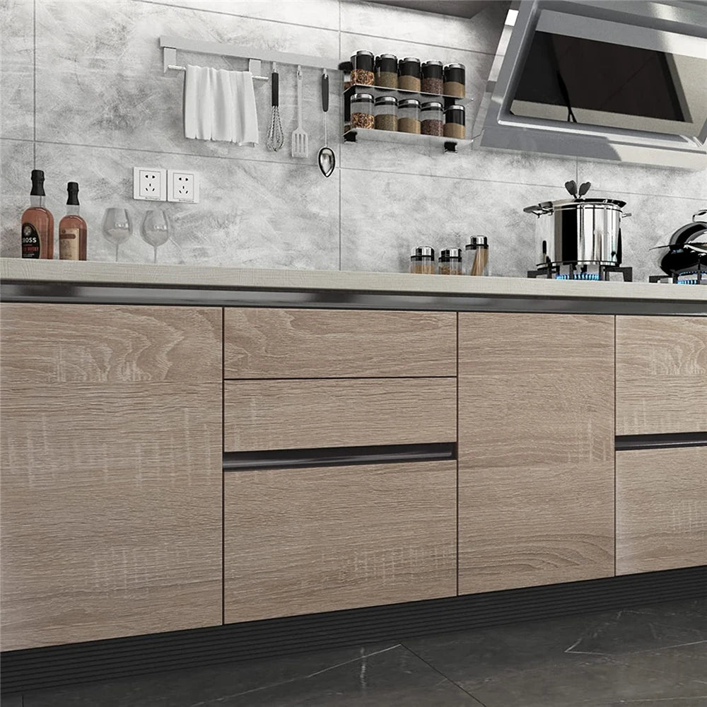 Kitchen with doors and drawers covered in pale wood effect vinyl wrap
