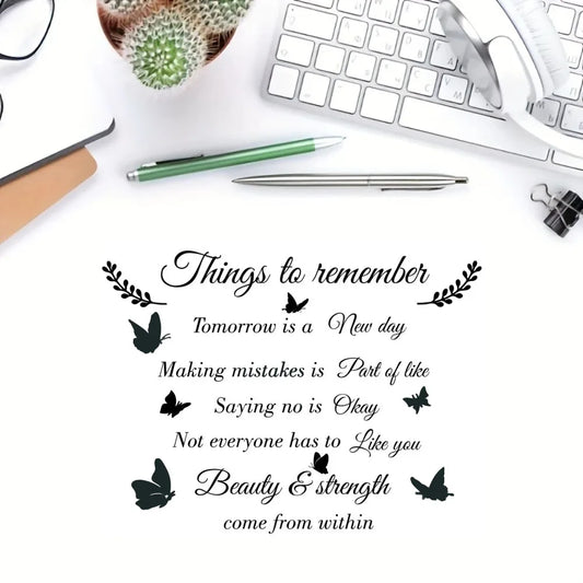 Muursticker met de Engelse tekst “Things to remember”, zwarte takjes en vlinders op een witte achtergrond