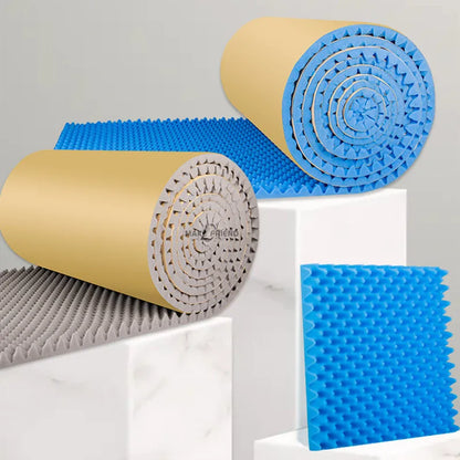Rolls of blue and grey acoustic foam with kraft paper backs and a blue piece, on white stands