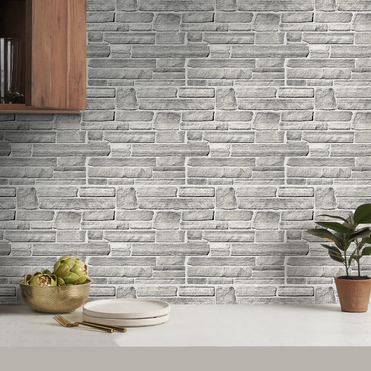 Kitchen wall covered with grey stone effect panels behind the worktop