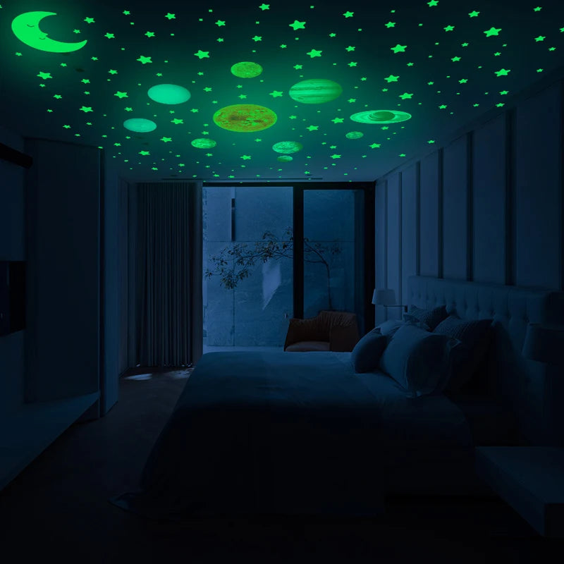 Dark room with stars and planets glowing green on the ceiling and wall
