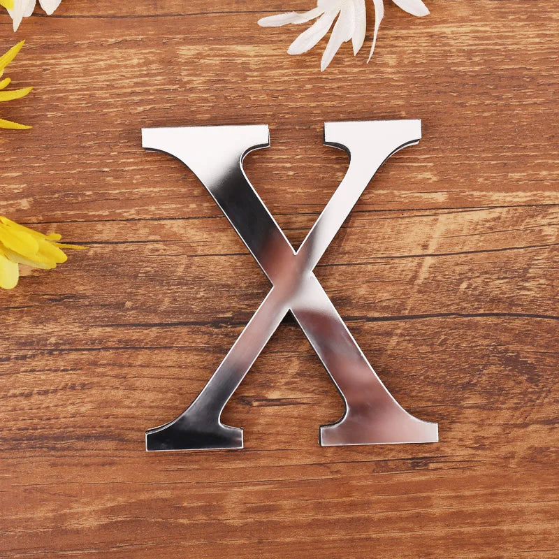Letter X in silver mirror acrylic, 20 cm, on a wooden table with flowers
