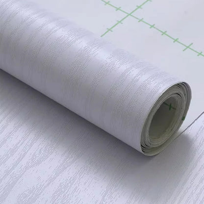Roll of white wood effect self-adhesive vinyl with grey grain