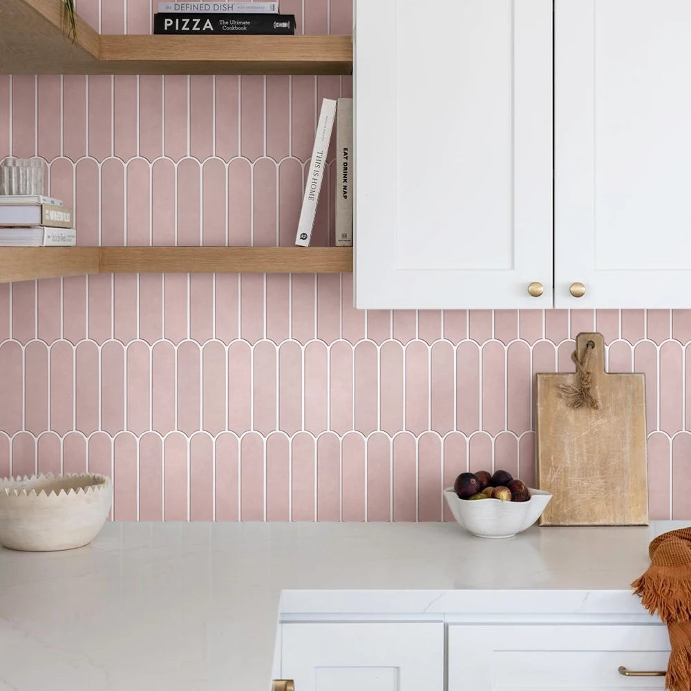 Dusty pink kitchen splashback with wooden shelves and tall white cupboards