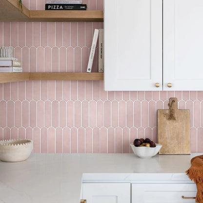 Dusty pink kitchen splashback with wooden shelves and tall white cupboards