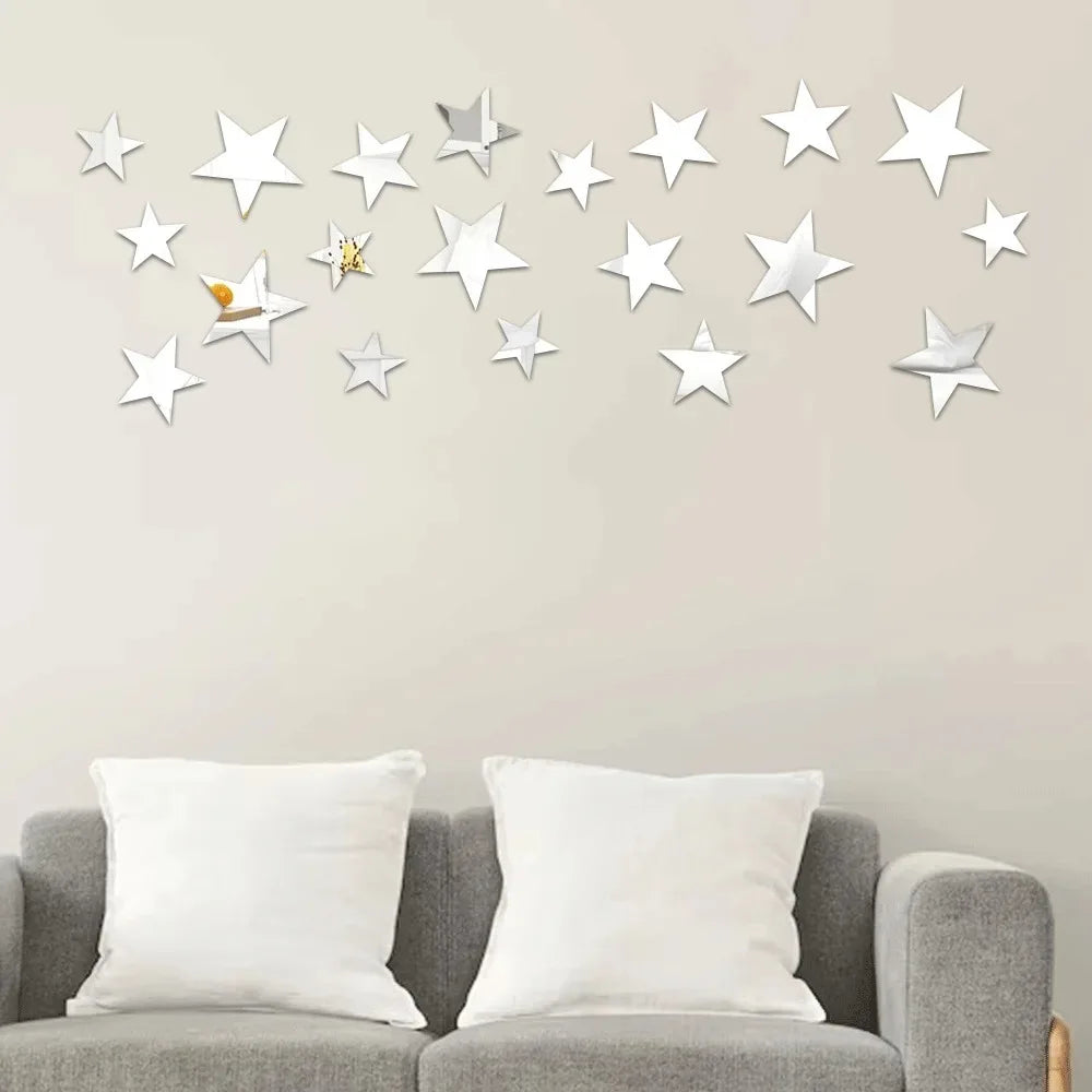 Silver five-pointed stars on a beige wall above a grey sofa