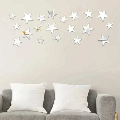 Silver five-pointed stars on a beige wall above a grey sofa