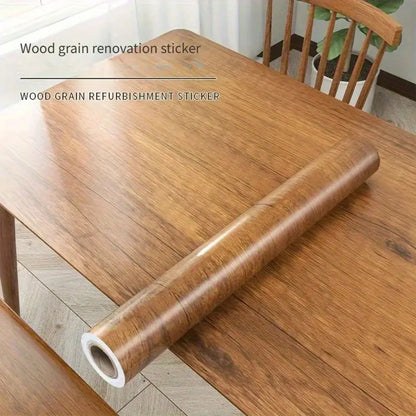 Roll of honey chestnut wood effect self-adhesive vinyl on a table