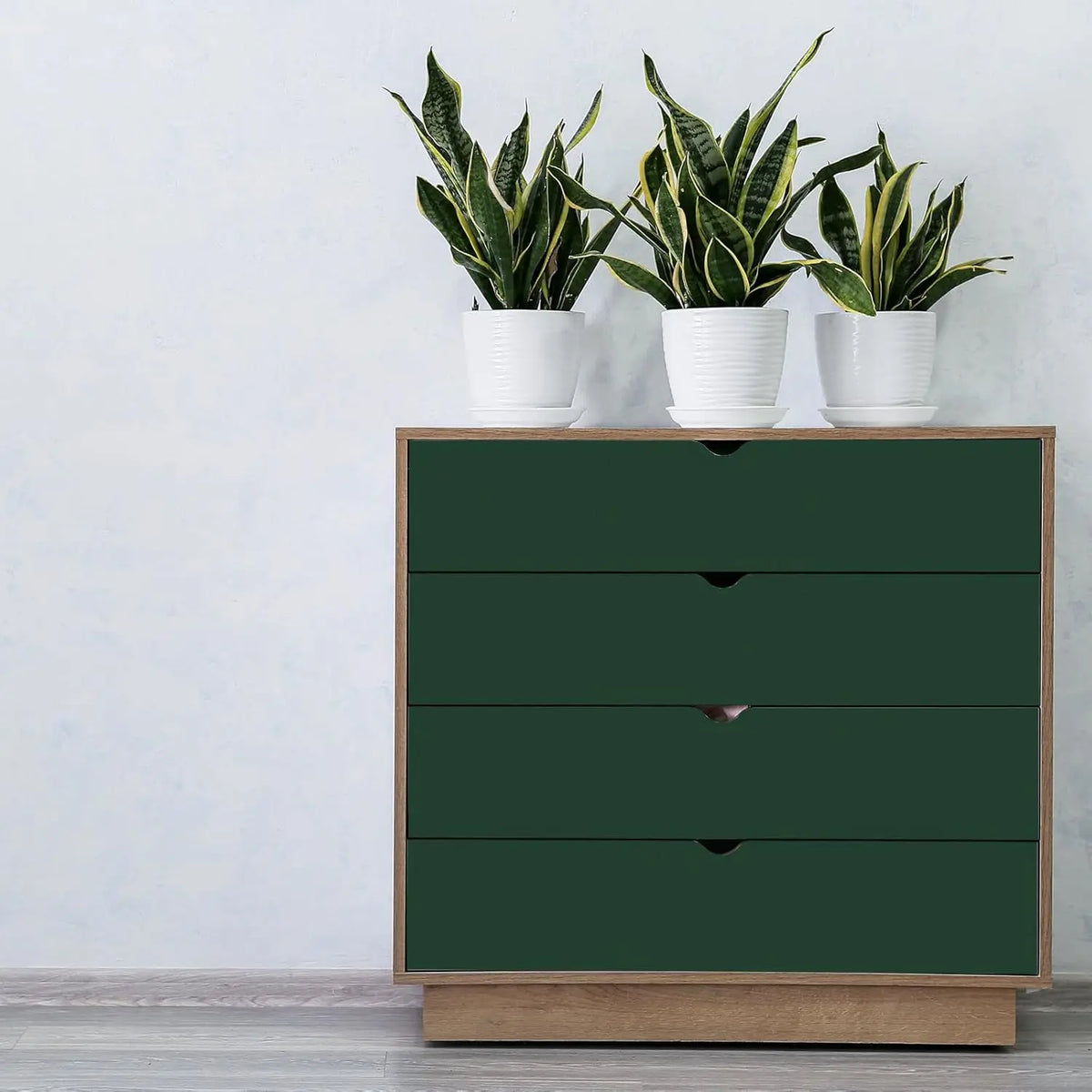 Kommode mit Schubladen, die mit dunkelgrüner Möbelfolie beklebt sind