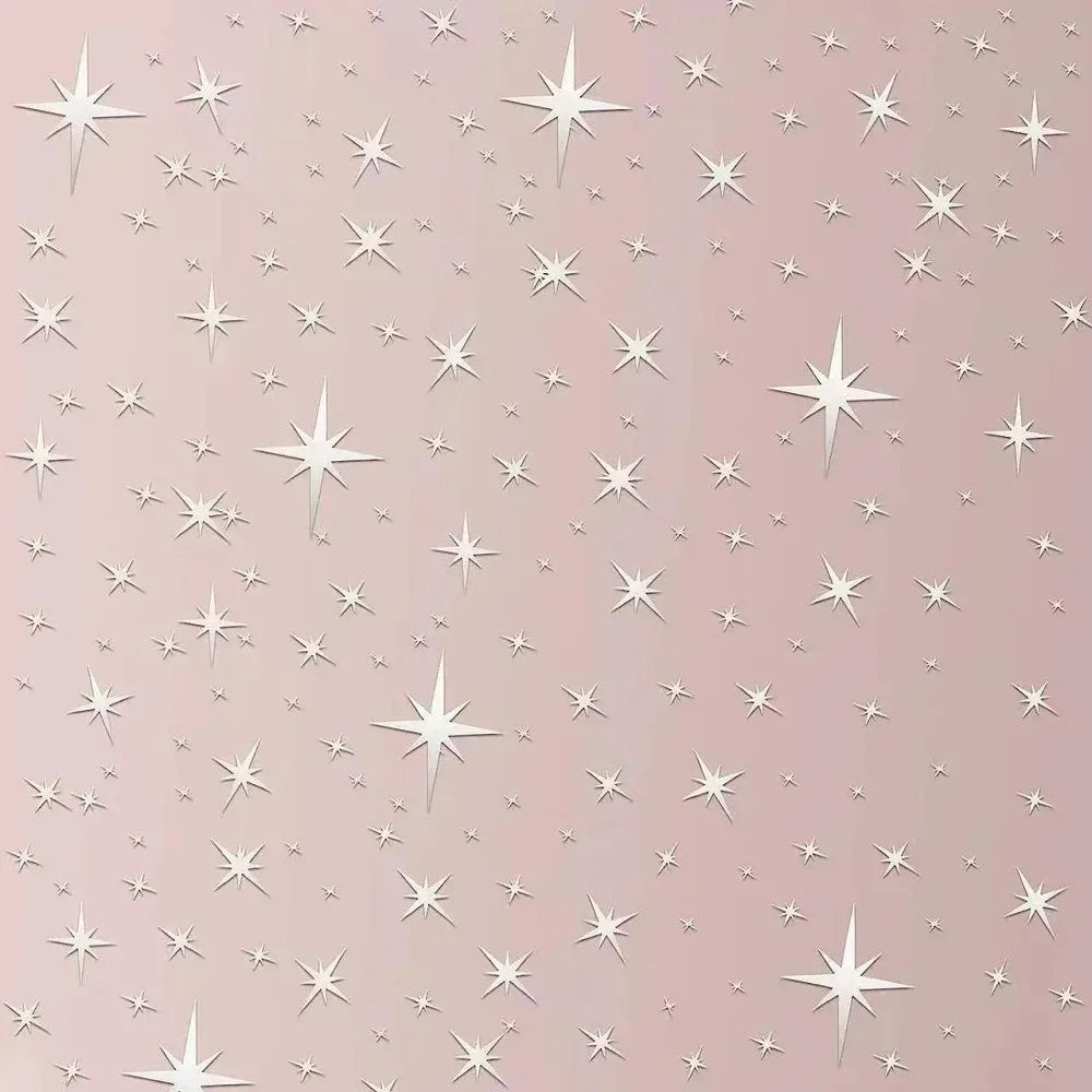 Close-up of sparkling silver stars on a pink wall
