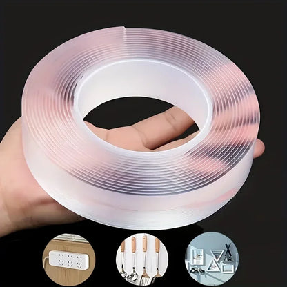 Roll of transparent double-sided tape held in one hand, on a black background