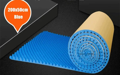Roll of blue acoustic foam with round bumps and a kraft paper back