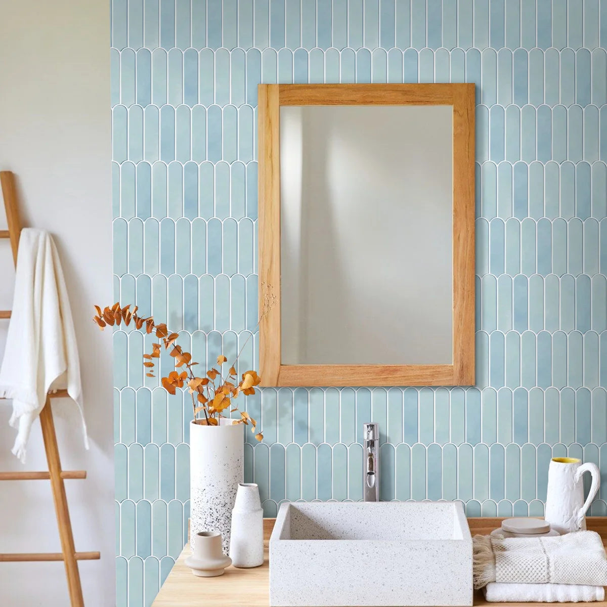 Bathroom with a sky blue wall covered in adhesive panels, wooden-framed mirror and washbasin