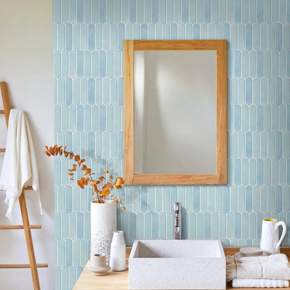 Bathroom with a sky blue wall covered in adhesive panels, wooden-framed mirror and washbasin