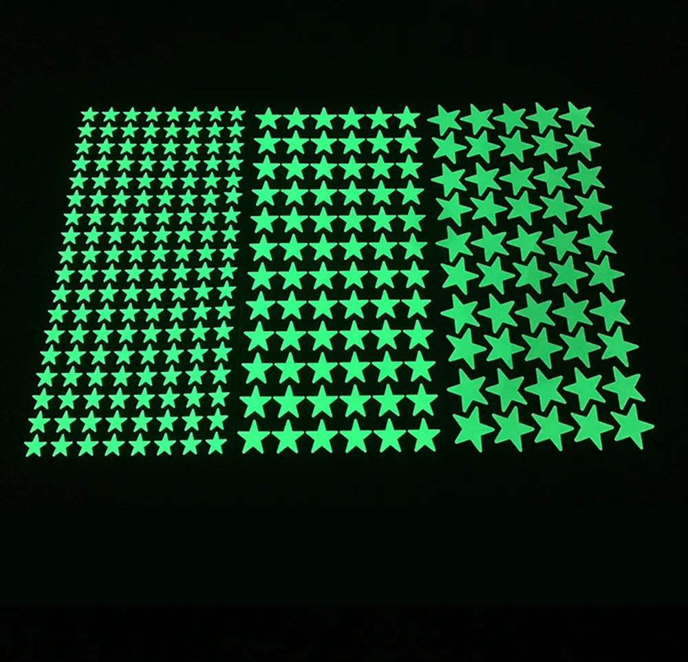 Three sheets of glow in the dark adhesive stars in different sizes, on black