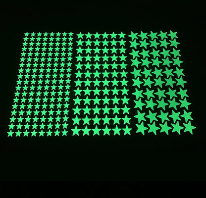 Three sheets of glow in the dark adhesive stars in different sizes, on black
