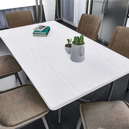 White table with chairs, a book and a plant, covered in white wood effect vinyl wrap