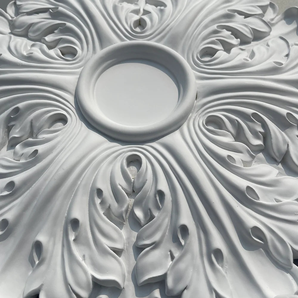 Close-up of the central hollow and the leaf relief of the ceiling rose