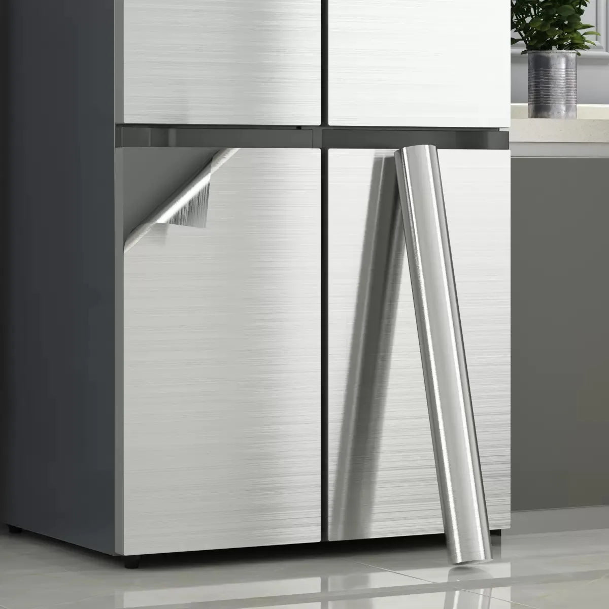Two-door fridge with stainless steel effect vinyl and a roll leaning beside it