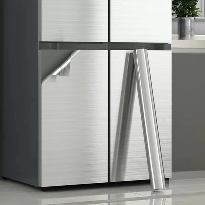 Two-door fridge with stainless steel effect vinyl and a roll leaning beside it