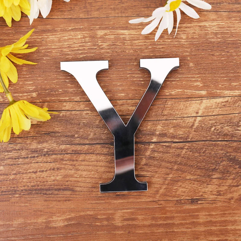 Letter Y in silver mirror acrylic, 20 cm, on a wooden table with flowers