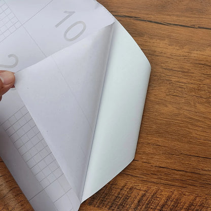 Paperin irrottaminen puukuvioisen tarrakalvon takapuolelta