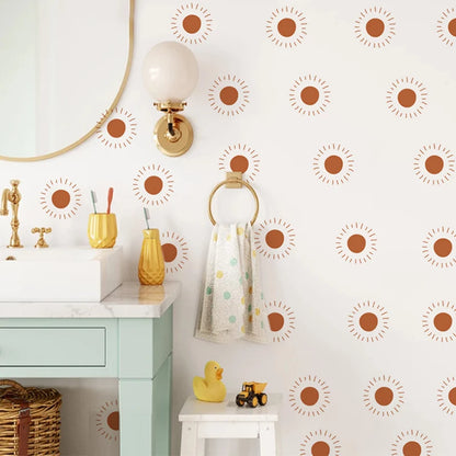 Bathroom with a basin and wall decorated with orange sun stickers