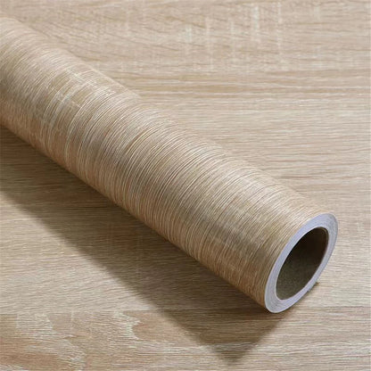 Roll of light wood effect vinyl wrap on a wooden background