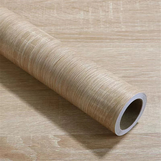 Roll of light wood effect vinyl wrap on a wooden background